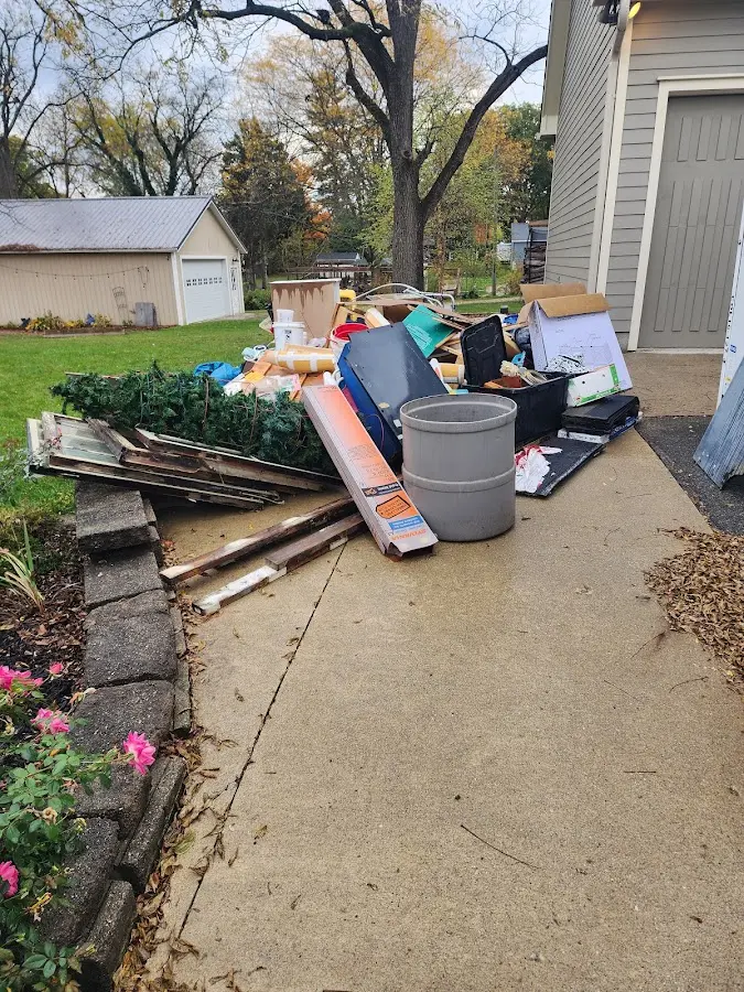 Dumpster being loaded with debris for Commercial Dumpster Rental in Ferris